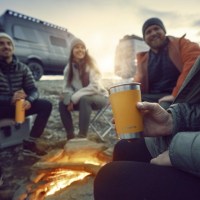 MarineWarehouse/Friends-sitting-around-a-campfire-drinking-out-of-Dometic-16oz-stainless-steel-cups__10614.1739477376