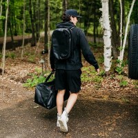 MarineWarehouse/Man-Carrying-a-Mission-CASSI-58L-Duffel-Tote-in-the-woods__51551.1739477272